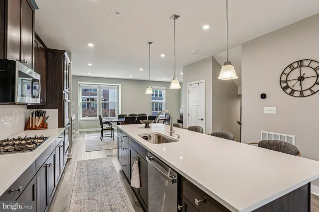 a kitchen with stainless steel appliances a sink stove and refrigerator
