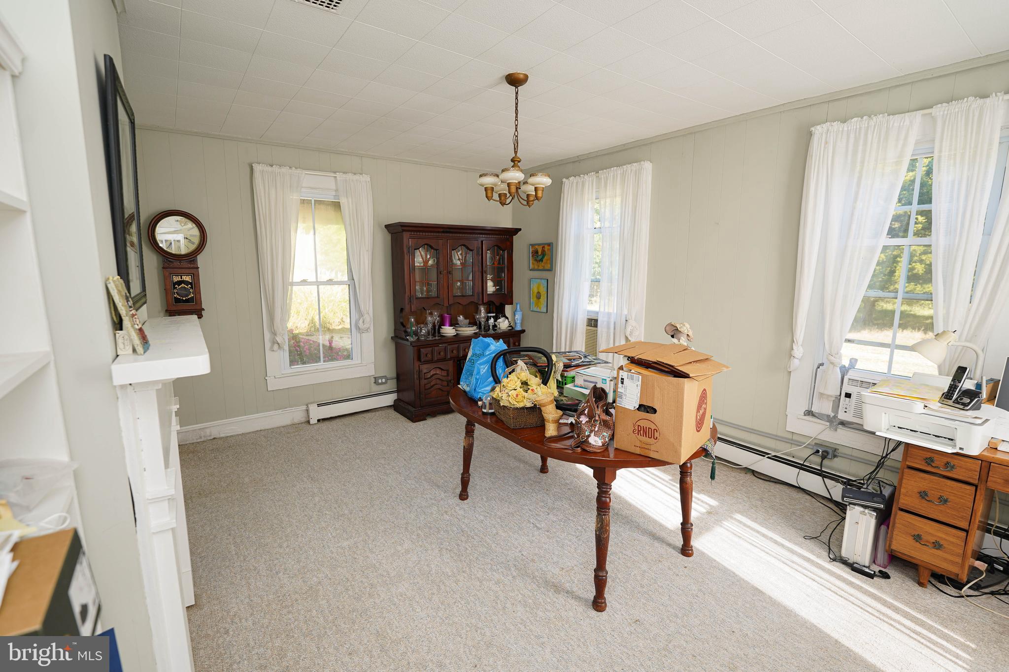 23392 Custom House Road Deal Island, MD 21821 - Photo 11 of 44 a living room with furniture a window and a chandelier