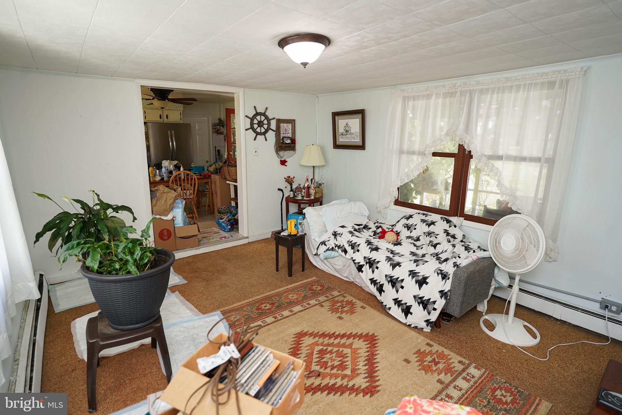 23392 Custom House Road Deal Island, MD 21821 - Photo 12 of 44 a bedroom with a bed and chandelier