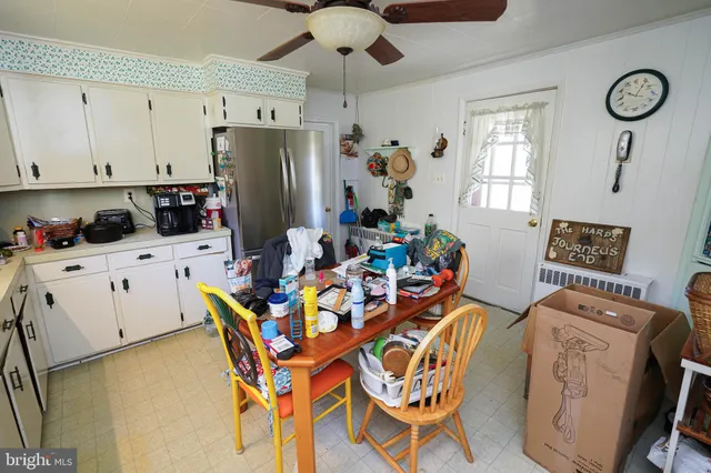 a work place with a chandelier fan and a window