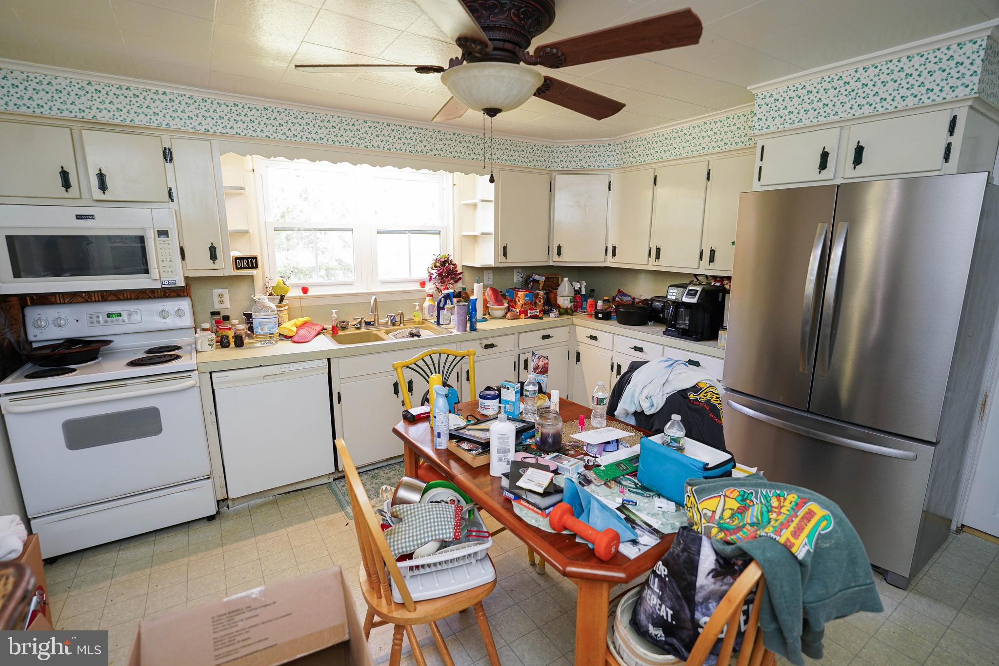 23392 Custom House Road Deal Island, MD 21821 - Photo 16 of 44 a kitchen with stainless steel appliances a stove a sink cabinets and a refrigerator