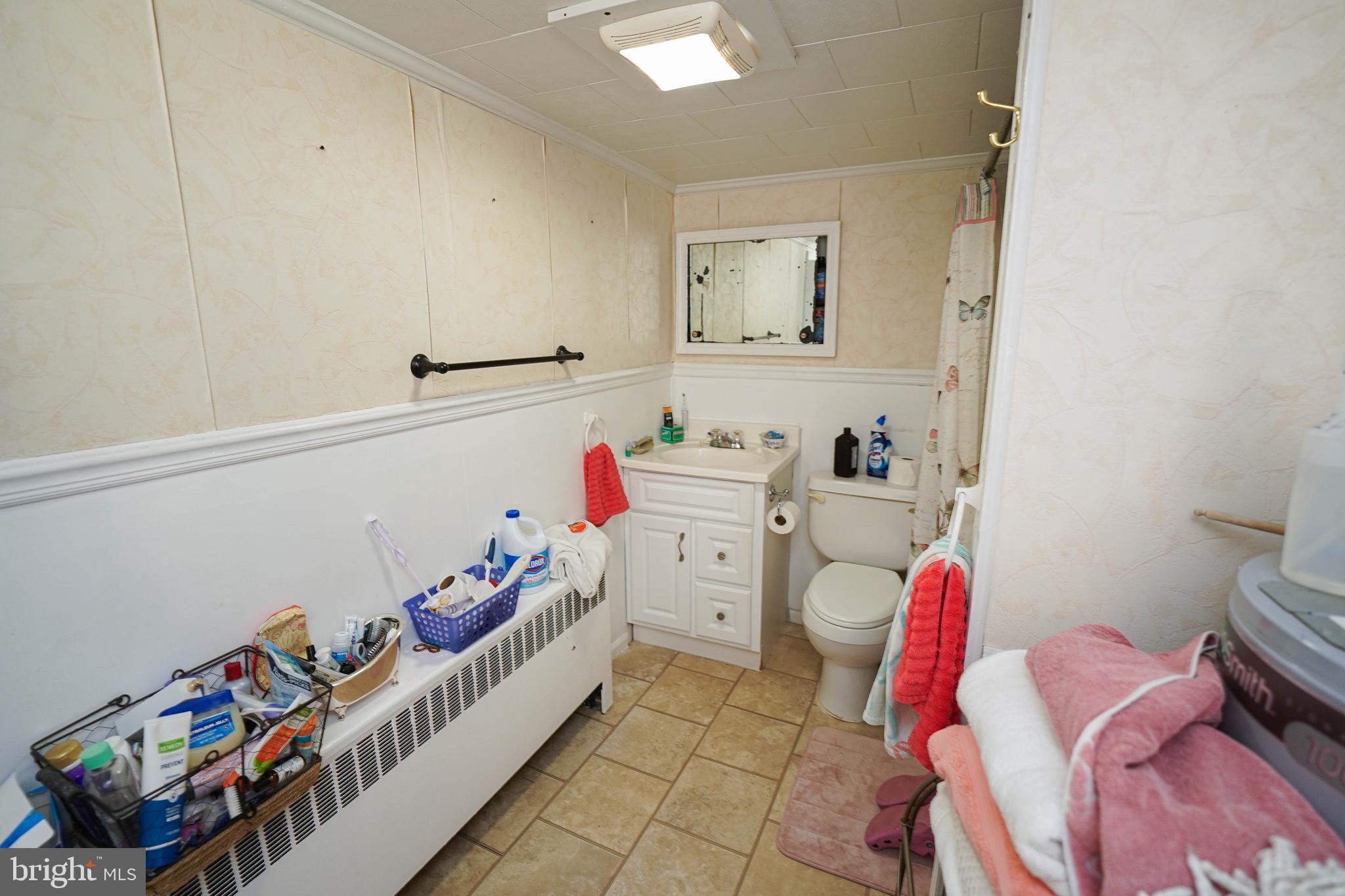 23392 Custom House Road Deal Island, MD 21821 - Photo 17 of 44 a bedroom with a bed and a window