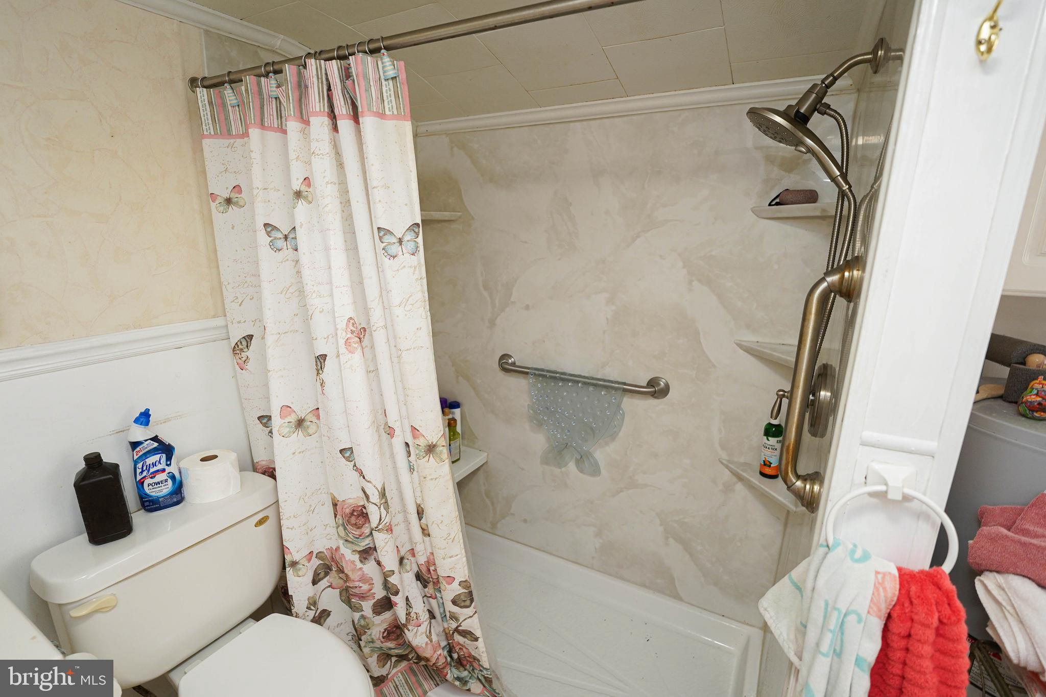 23392 Custom House Road Deal Island, MD 21821 - Photo 18 of 44 a bathroom with a shower curtain and a window