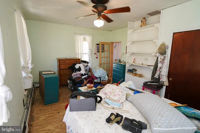 a bedroom with furniture and a wooden floor