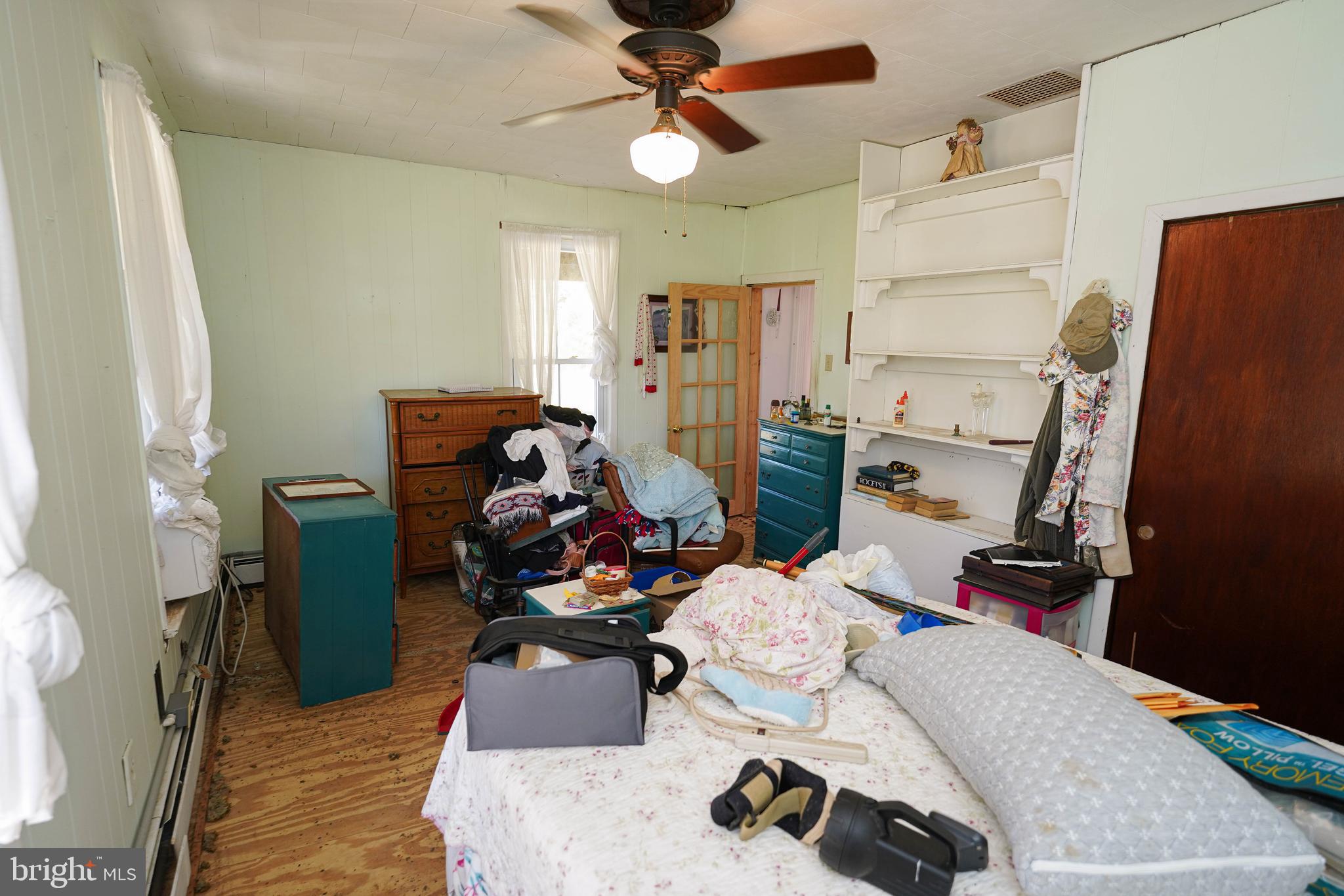 23392 Custom House Road Deal Island, MD 21821 - Photo 25 of 44 a bedroom with furniture and a wooden floor
