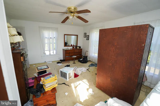 a bedroom with a bed furniture and a flat tv screen