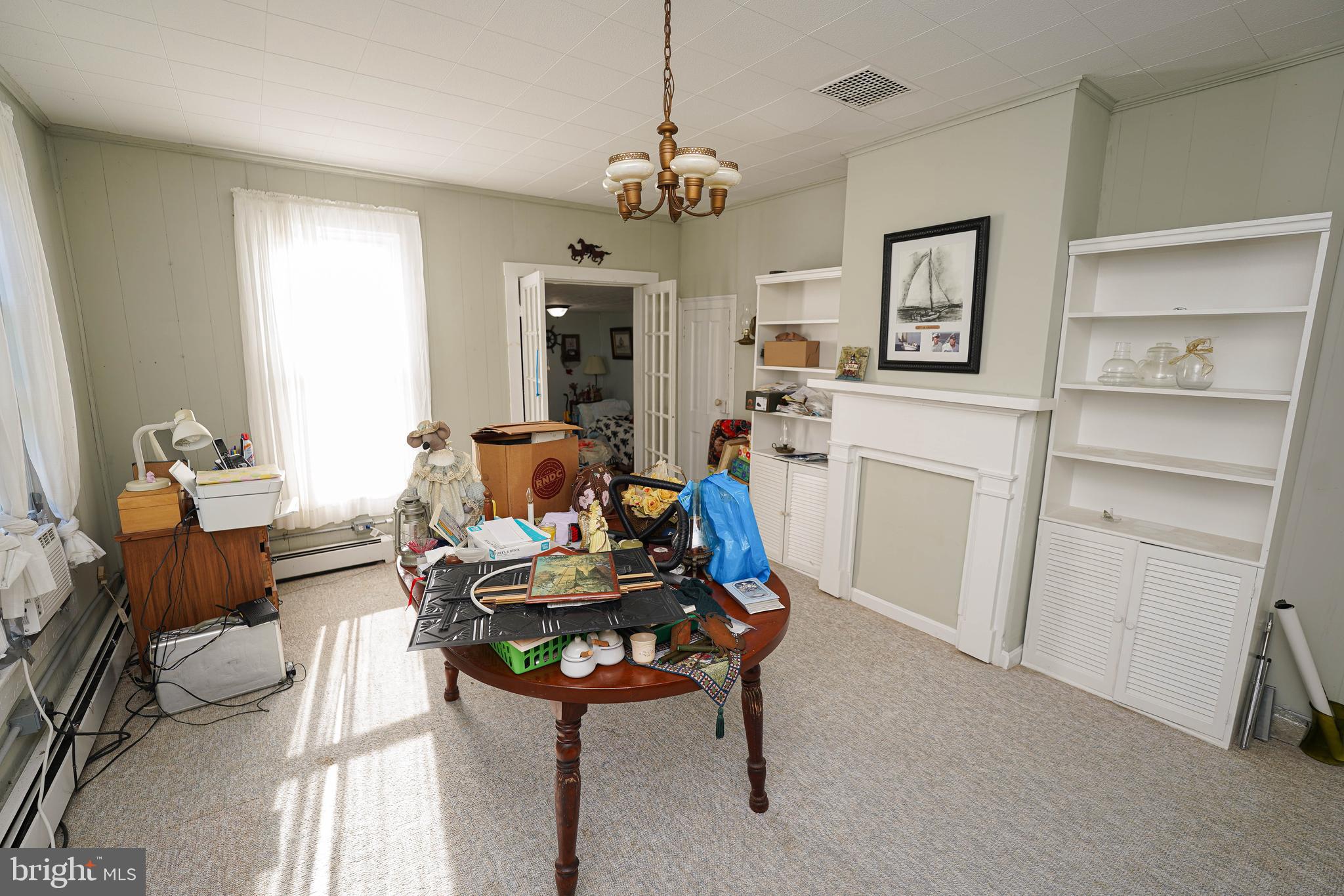 23392 Custom House Road Deal Island, MD 21821 - Photo 10 of 44 a living room with furniture a chandelier and a dining table