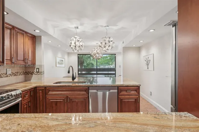a kitchen with stainless steel appliances granite countertop a sink stove and refrigerator