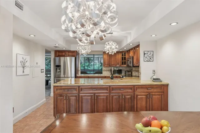 a kitchen with stainless steel appliances granite countertop a stove and cabinets