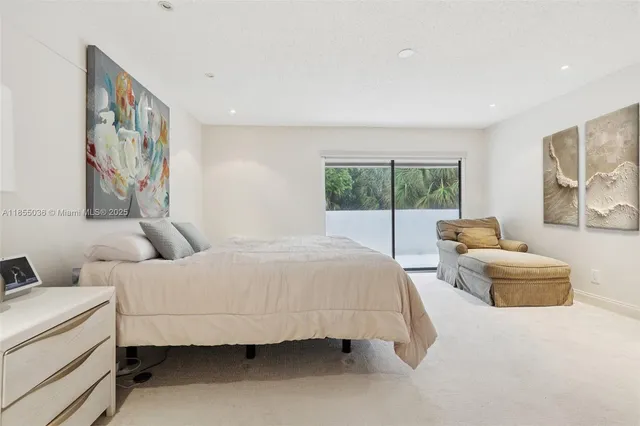 a bedroom with a large bed and a couch