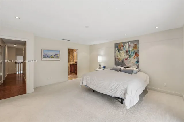 a bedroom with a bed and a painting