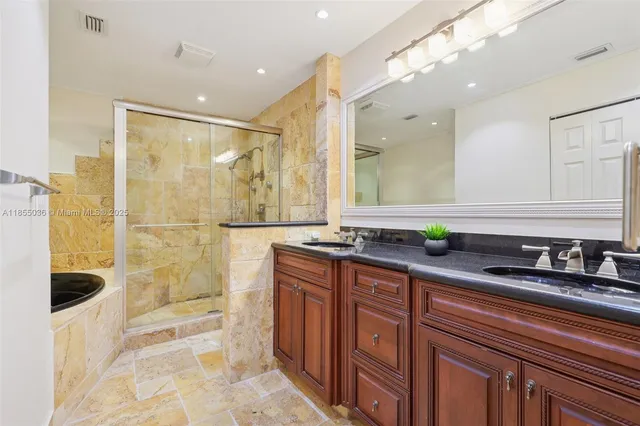a bathroom with a double vanity sink and a mirror