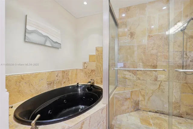 a bathroom with a bathtub and shower