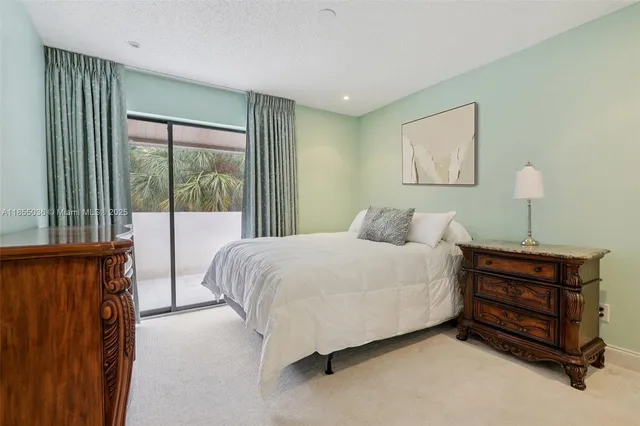 a bedroom with a bed lamp and window