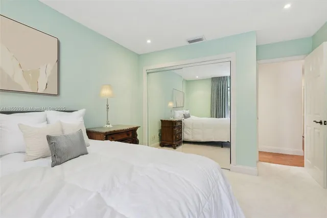 a bedroom with a bed and a painting