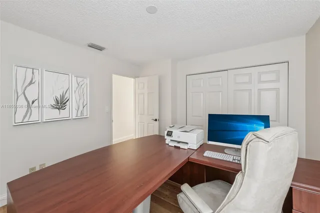 a view of a workspace with furniture and wooden floor