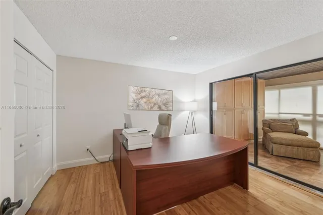 a view of a room with wooden floor and furniture