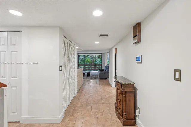 a front view of a house with a garden and plants