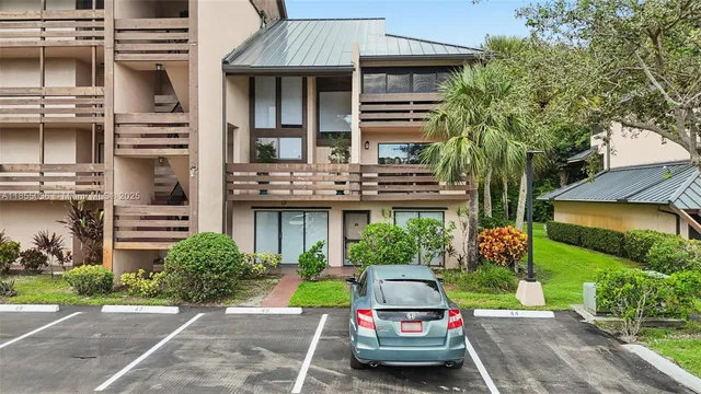 a view of a car parked in front of a house