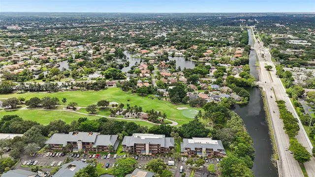 an aerial view of residential houses with outdoor space and river