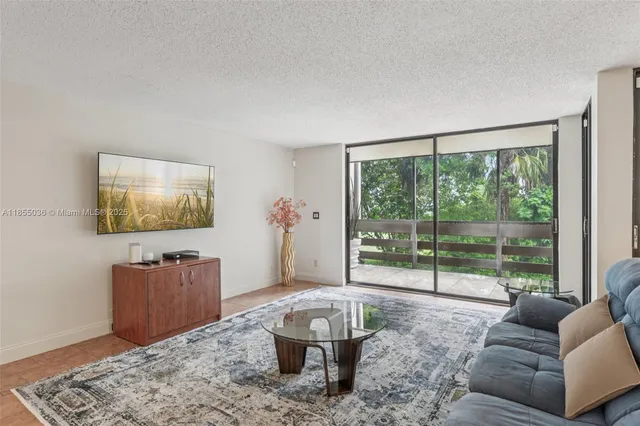 a living room with furniture and a floor to ceiling window