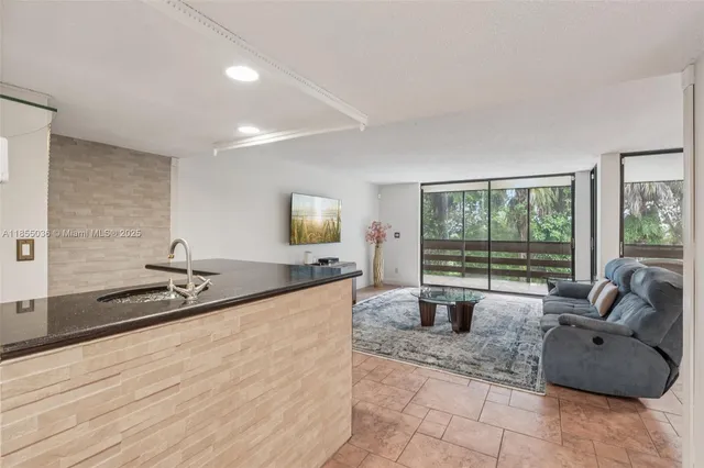 a kitchen view living space with furniture and wooden floor