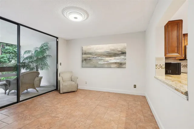 a view of a livingroom with furniture and a large window