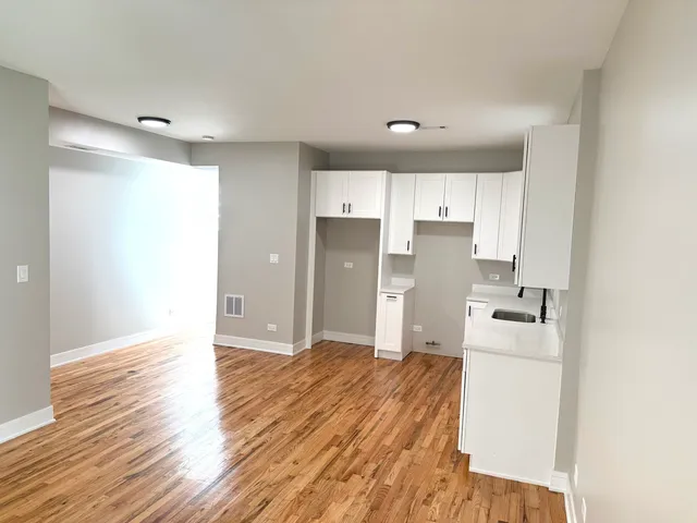 a kitchen with a refrigerator sink and wooden cabinets