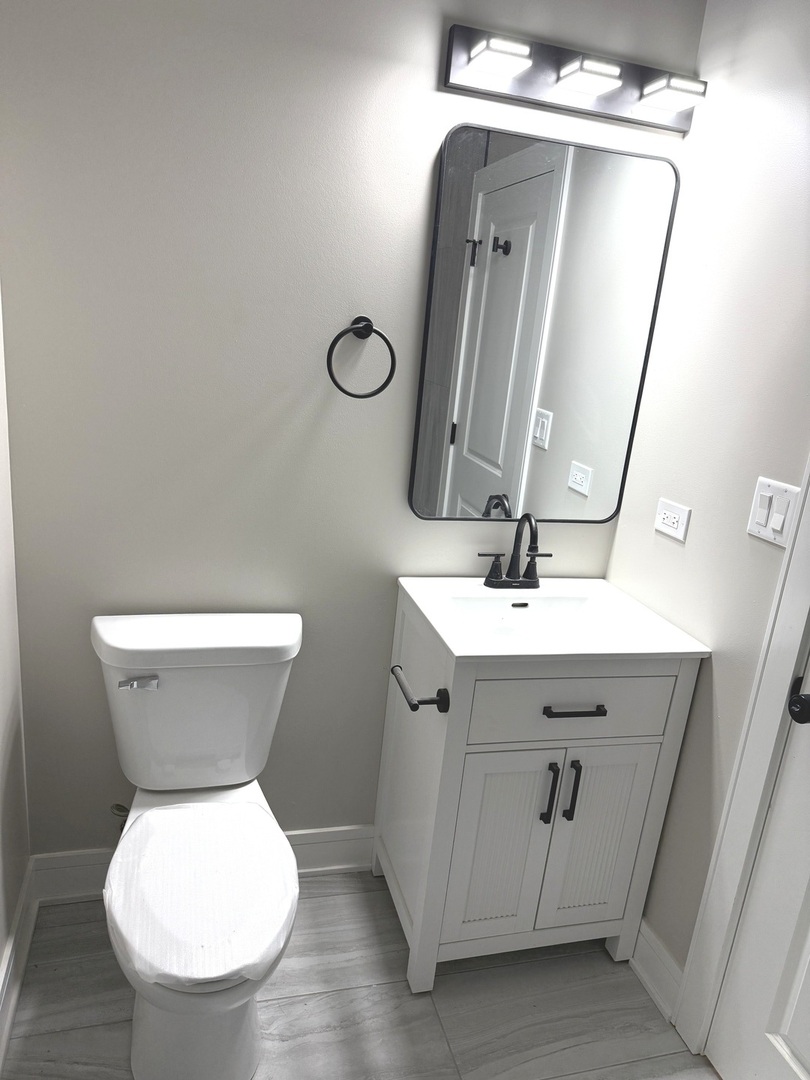 1440 South Kedvale Avenue Chicago, IL 60623 - Photo 4 of 10 a bathroom with a toilet sink and mirror