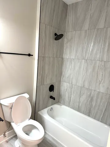 a bathroom with a toilet a sink and bathtub