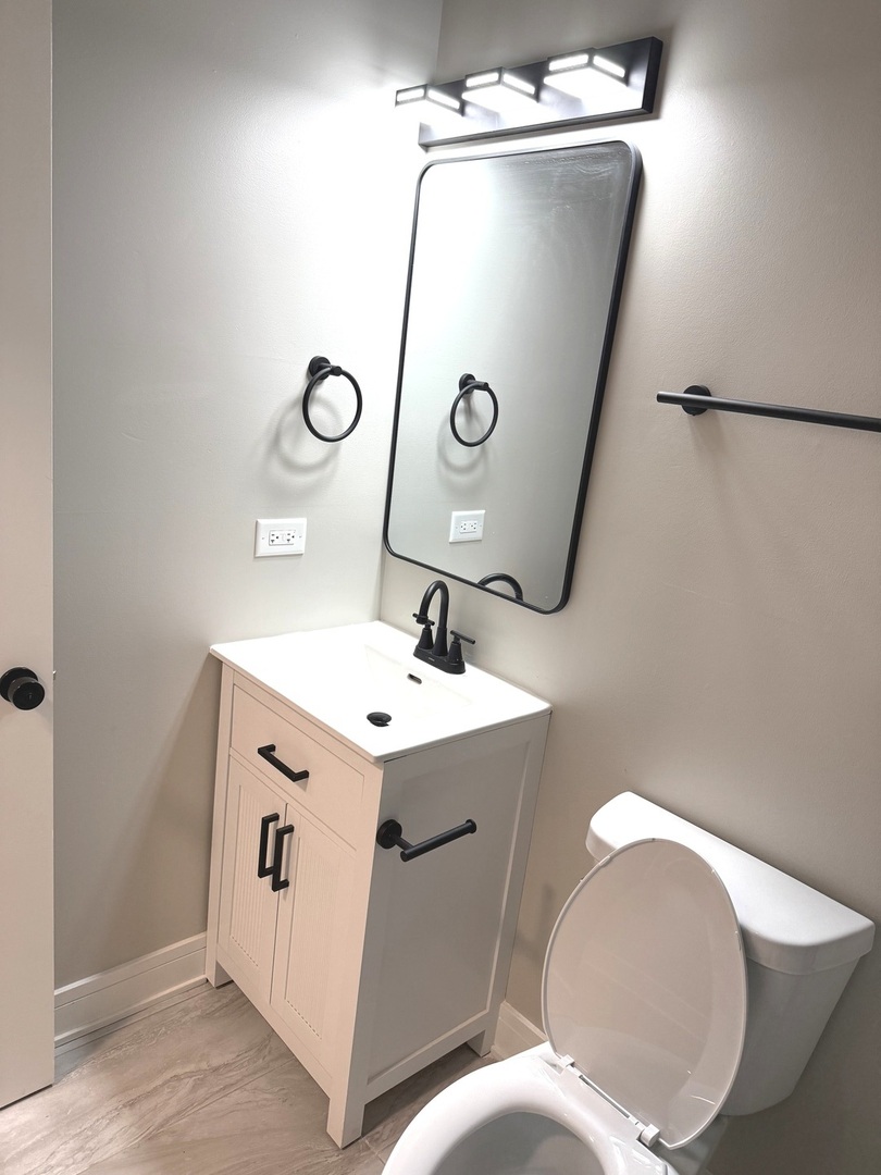 1440 South Kedvale Avenue Chicago, IL 60623 - Photo 6 of 10 a bathroom with a sink and mirror