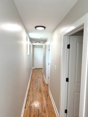 a view of hallway with wooden floor