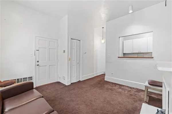 a view of room with furniture and a ceiling fan