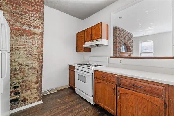 a kitchen with stainless steel appliances granite countertop a stove and a microwave