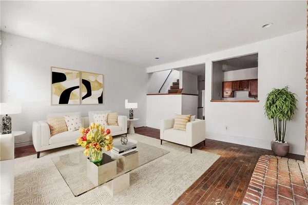 a living room with furniture and a potted plant