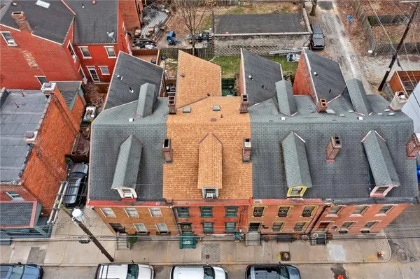 an aerial view of residential houses with outdoor space