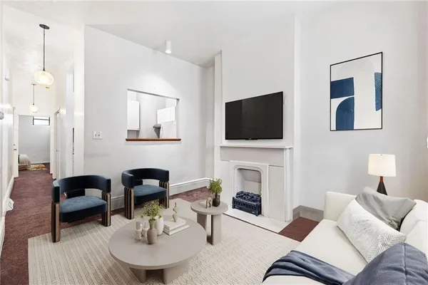 a living room with furniture a fireplace and a flat screen tv