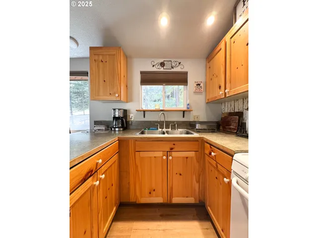 a kitchen with stainless steel appliances granite countertop a sink and a stove
