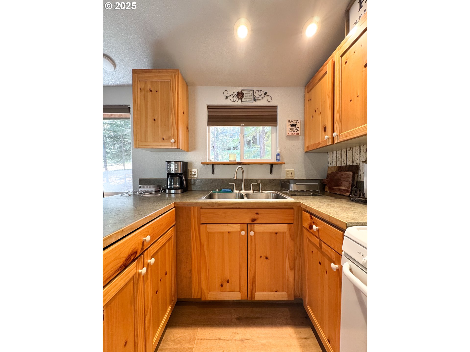 255 East North Street Sumpter, OR 97877 - Photo 3 of 20 a kitchen with stainless steel appliances granite countertop a sink and a stove