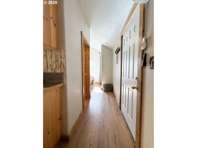 a view of a hallway with wooden floor