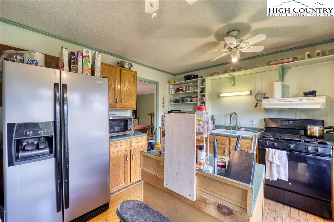 191 Alex Wellborn Road Deep Gap, NC 28618 - Photo 13 of 39 a kitchen with stainless steel appliances granite countertop a refrigerator and a stove
