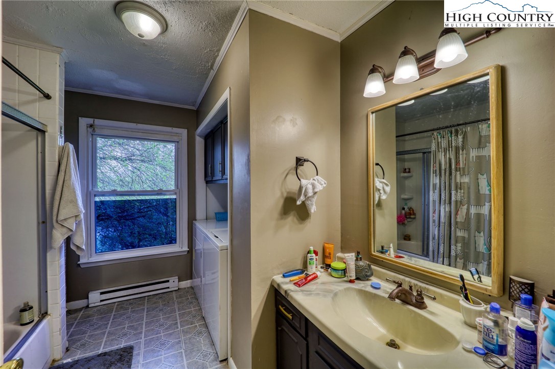191 Alex Wellborn Road Deep Gap, NC 28618 - Photo 16 of 39 a bathroom with a sink double vanity and a mirror