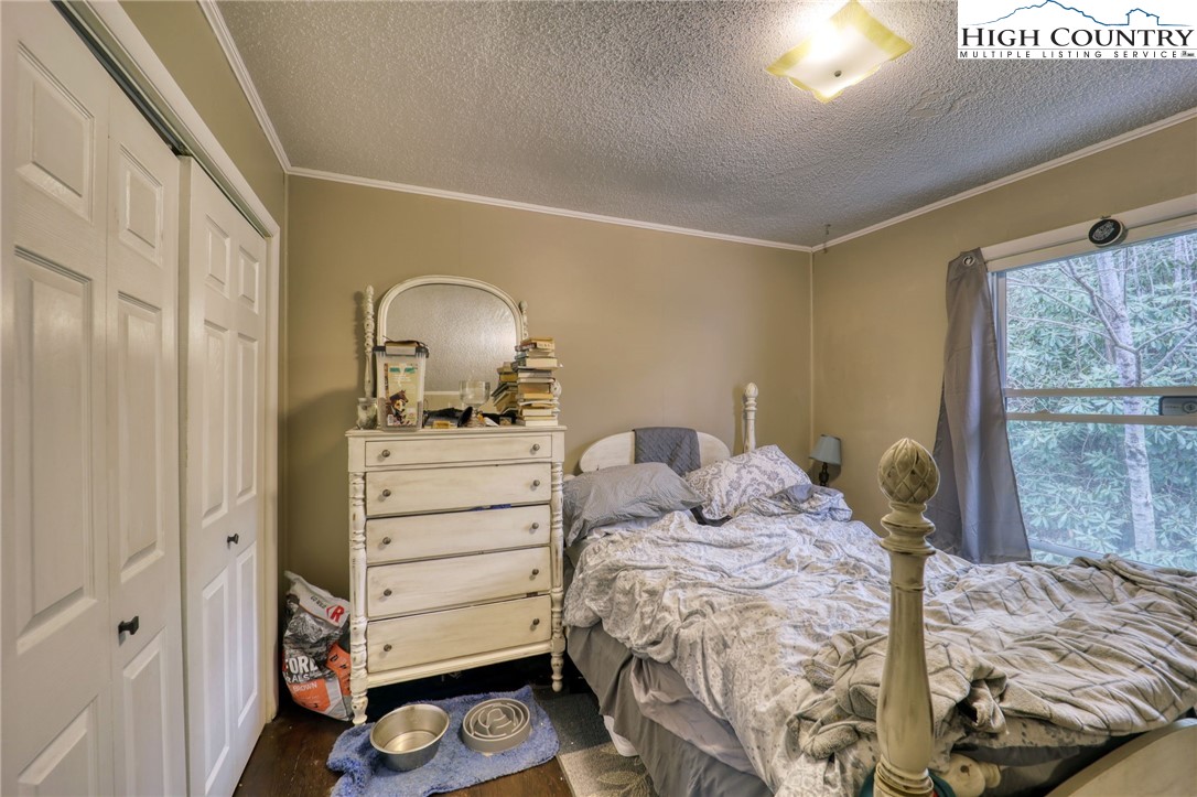 191 Alex Wellborn Road Deep Gap, NC 28618 - Photo 21 of 39 a bedroom with a bed and a dresser