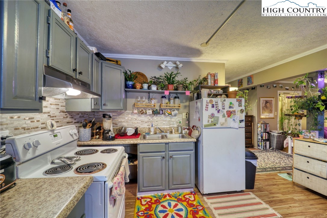 191 Alex Wellborn Road Deep Gap, NC 28618 - Photo 25 of 39 a kitchen with stainless steel appliances granite countertop a sink stove and refrigerator