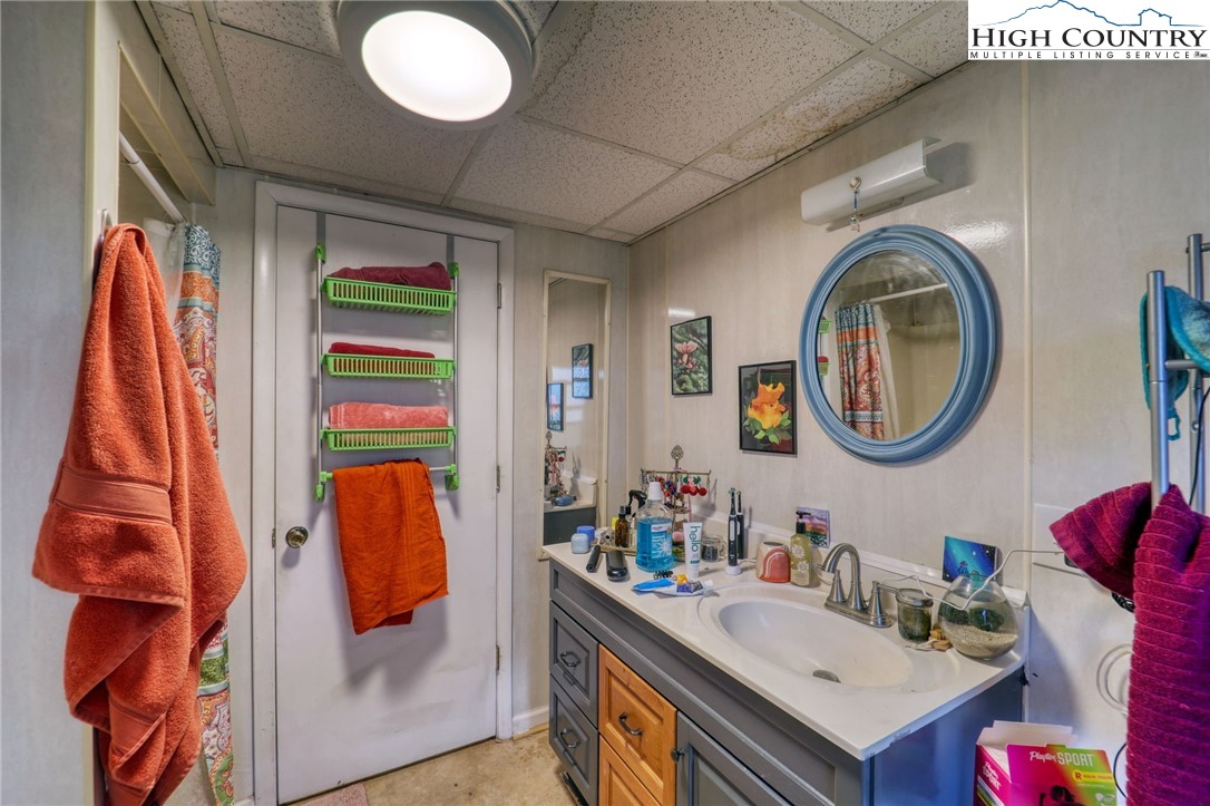 191 Alex Wellborn Road Deep Gap, NC 28618 - Photo 29 of 39 a bathroom with a sink and a mirror
