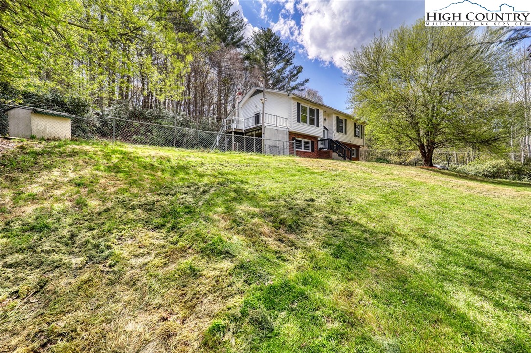 191 Alex Wellborn Road Deep Gap, NC 28618 - Photo 3 of 39 a view of house with yard and trees in background