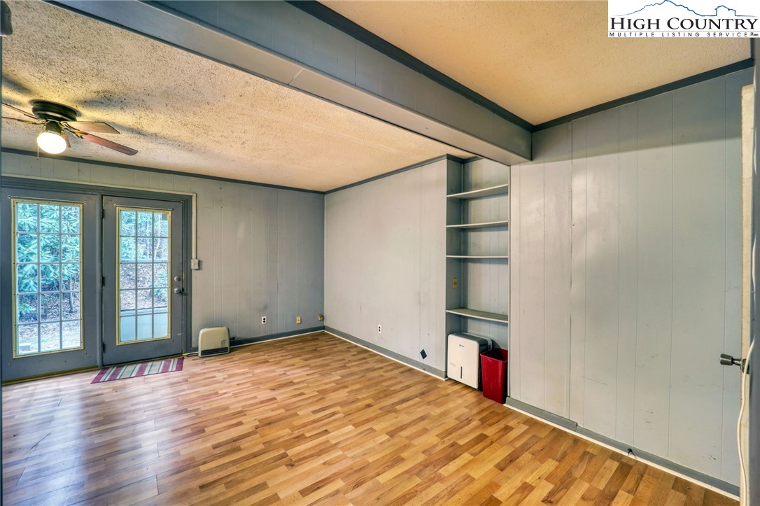 191 Alex Wellborn Road Deep Gap, NC 28618 - Photo 34 of 39 a view of empty room with wooden floor and fan