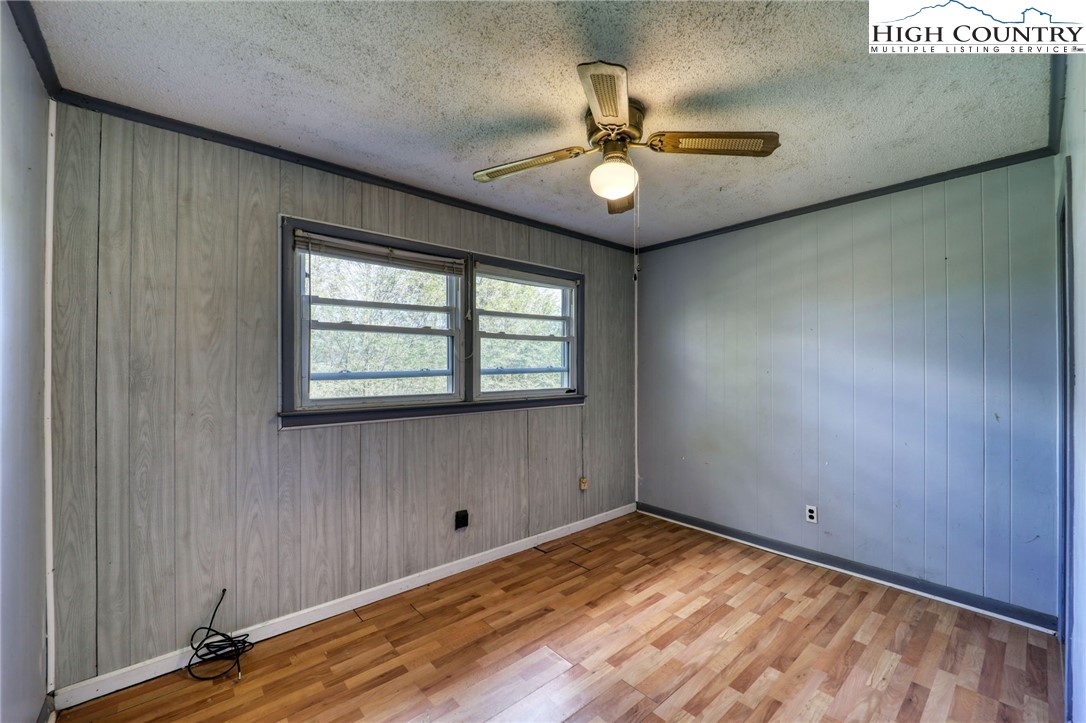 191 Alex Wellborn Road Deep Gap, NC 28618 - Photo 35 of 39 a view of empty room with a window and ceiling fan