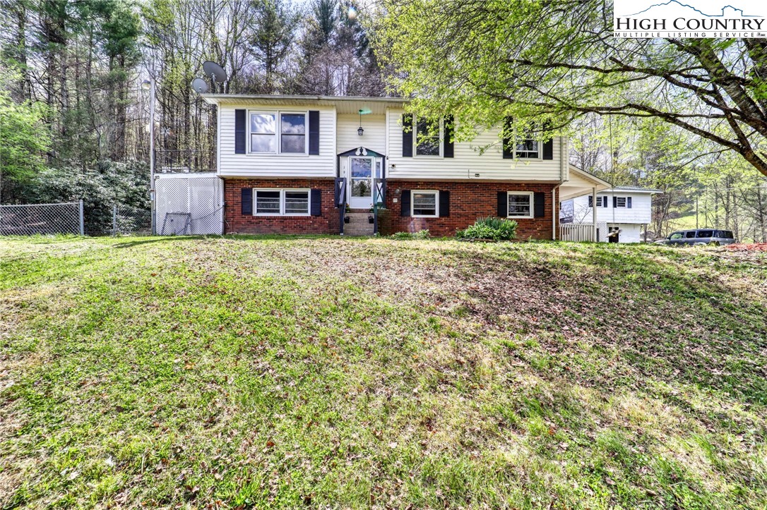 191 Alex Wellborn Road Deep Gap, NC 28618 - Photo 4 of 39 a front view of a house with garden