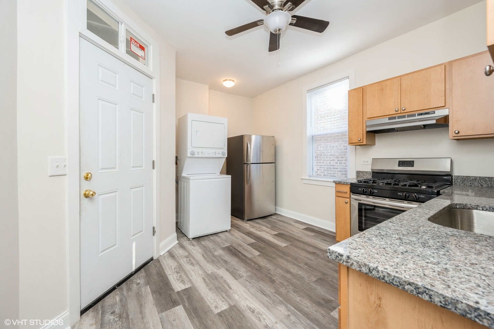 4954 West Augusta Boulevard, Unit 2 Chicago, IL 60651 - Photo 7 of 15 a kitchen with stainless steel appliances granite countertop a stove a refrigerator and a sink